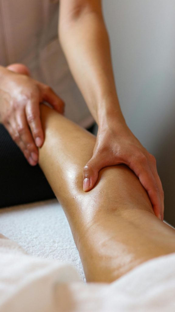 Close-up of a relaxing massage therapy session in Geneva with a focus on leg treatment.